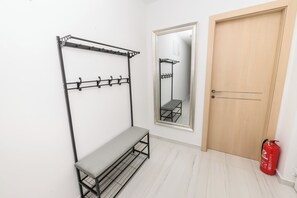 A room with a bench, a metal rack with hooks, a mirror, and a door. - Condo with 2 bdr and parking (Kaštel Stari)