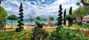 A coastal park with a bench, a fountain, and a view of the sea. - Condo with 2 bdr and parking (Kaštel Stari)