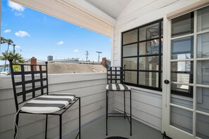 A balcony with two chairs and a window. - Classic Balboa Island Coastal Escape (Newport Beach)
