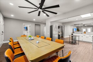 A modern kitchen with a refrigerator, stove, and microwave. - Pool • Hot tub • Basketball C. • Mini-Golf • Game Room • 26 Guests Max (Las Vegas)