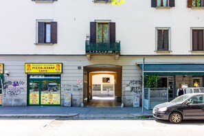 A building with a pizza and kebab shop, a sign indicating no parking, and a car parked on the street. - Jasmine House - MARTINI's Home, Milano (Milano)