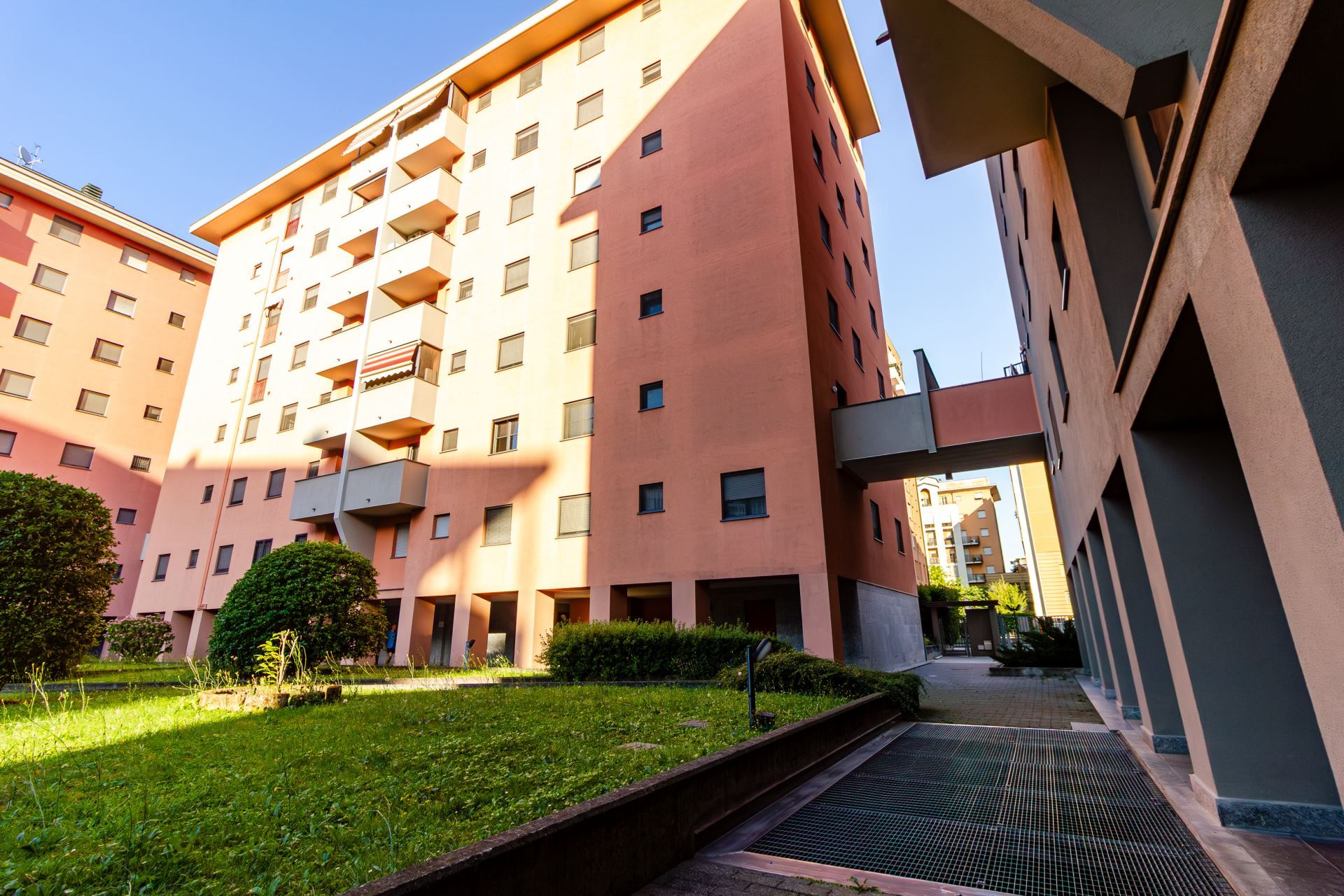 A multi-story residential building with balconies, a central courtyard, and a modern architectural design.