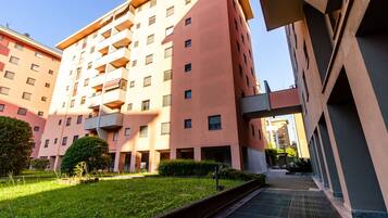 A multi-story residential building with balconies, a central courtyard, and a modern architectural design.