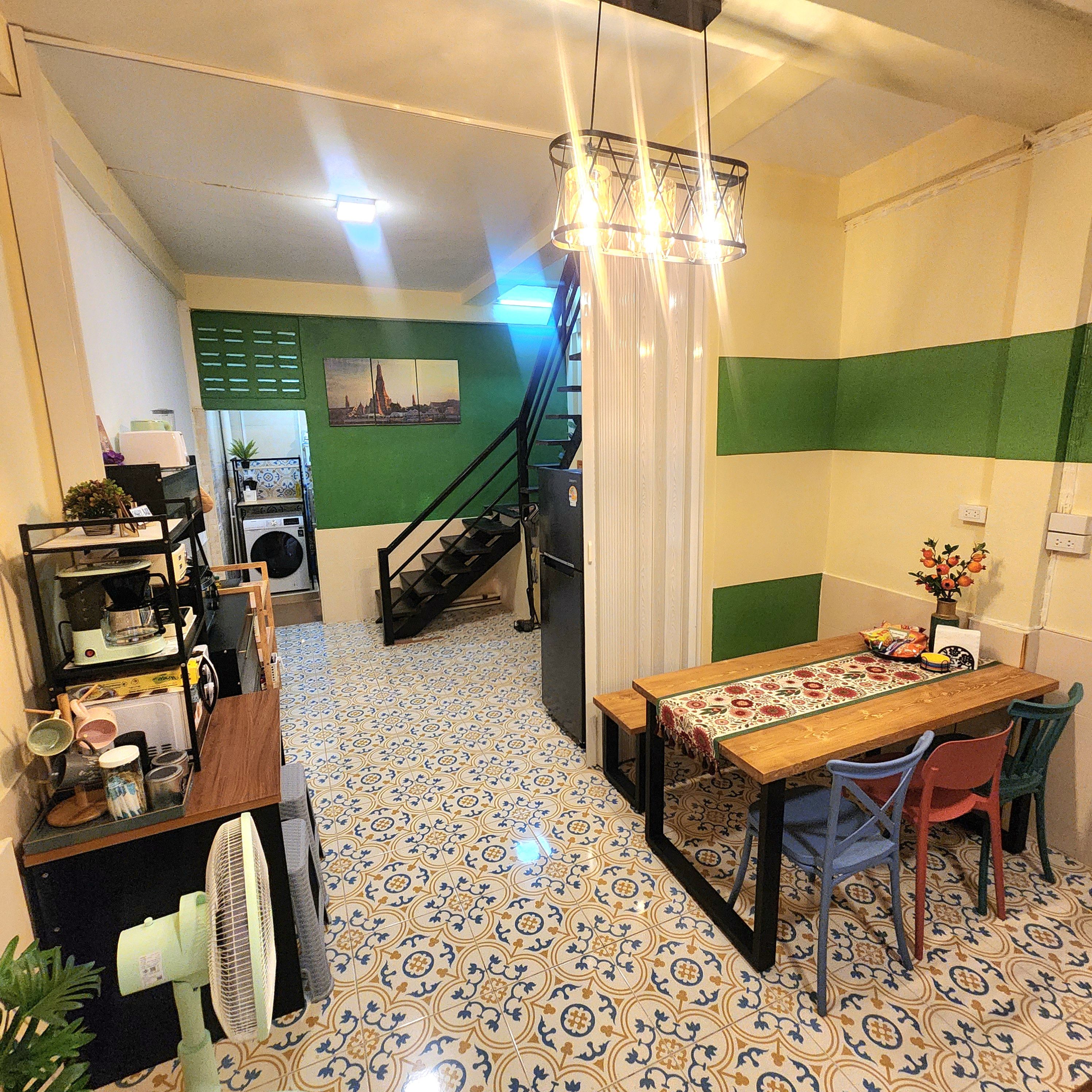 A dining area with a table, chairs, and a patterned floor.