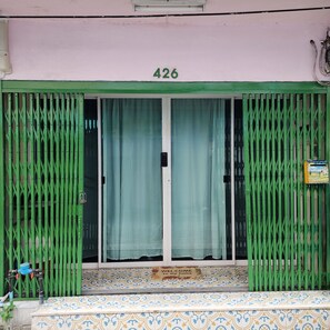 A building entrance with a green gate, a number 426 sign above, and a welcome sign at the bottom. - 3BR Local Bangkok Stay [10 Min Walk to BTS & Sathorn Pier ] • Easy City Access (Sathon)
