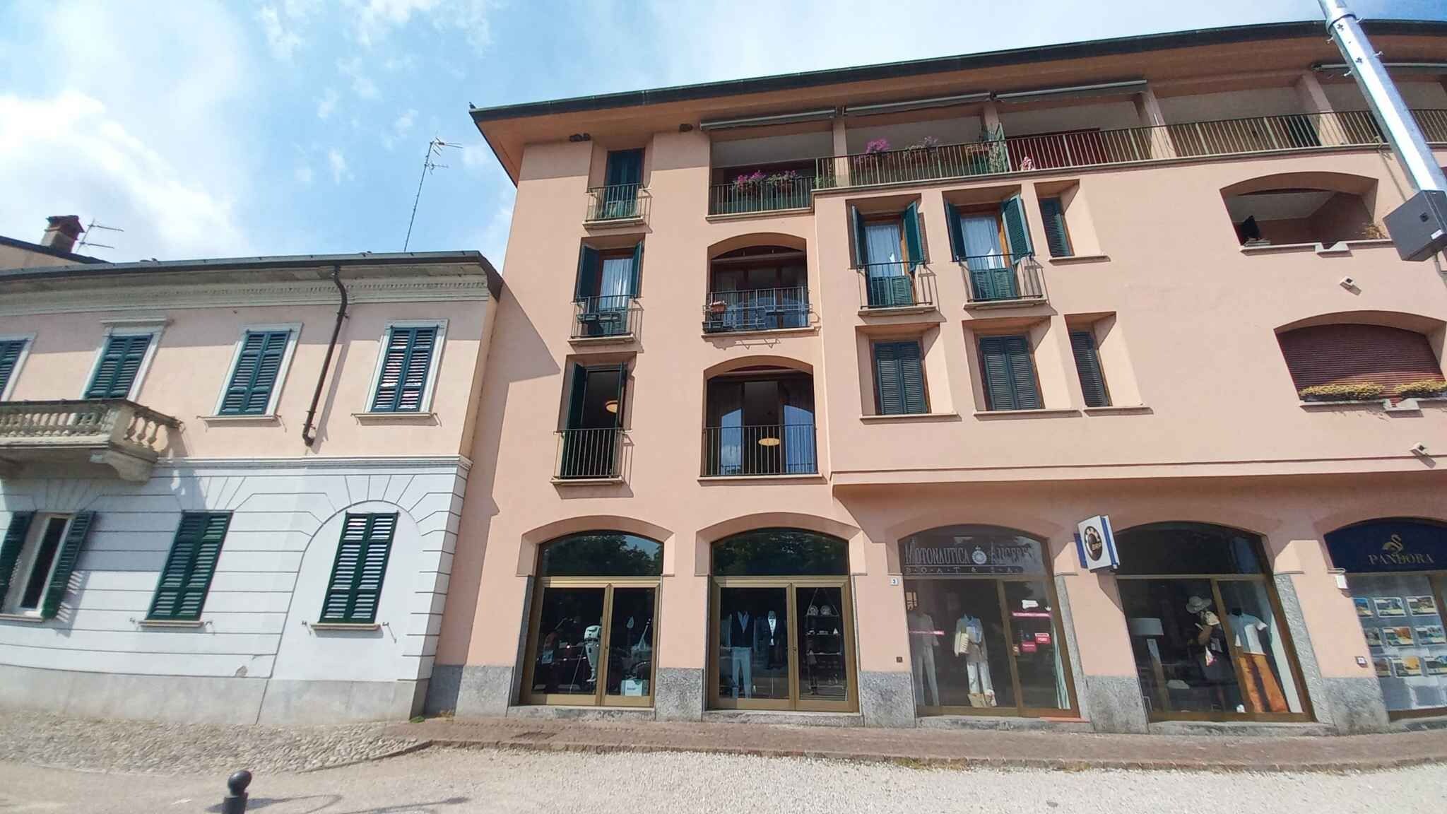 Un immeuble à plusieurs étages, avec un commerce au rez-de-chaussée et des logements aux étages supérieurs.