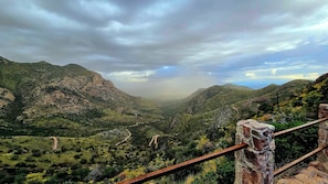 A mountainous landscape with a dirt path leading through a valley.