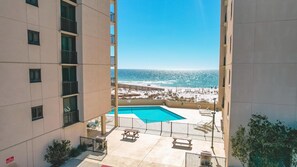 A pool area with a view of the beach and ocean. - Gulf Front | Huge Balcony | Direct Beach Access | BEACHBALL PROPERTIES (Orange Beach)