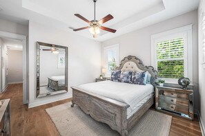 A bedroom with a large bed, a ceiling fan, a mirror, and a dresser. - 🦩Book Me Baby! Chillin' in Prominence🦩 (Inlet Beach)