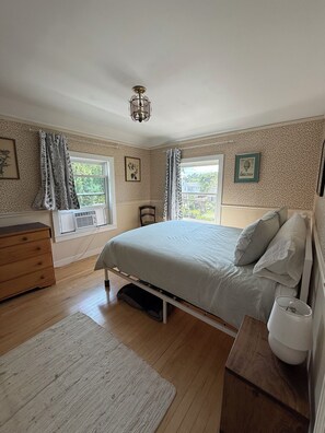A bedroom with a bed, dresser, and a window with a view. - Sun-Filled Brick Townhouse Near Downtown Bath (Bath)