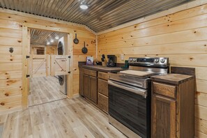 A wooden interior with a kitchen area featuring a stove, oven, and a coffee maker. - Welcome to the Sheriff's Office (Stanton)