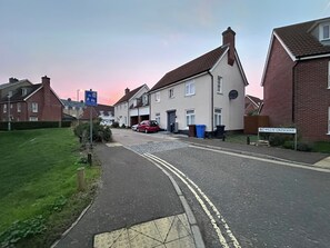 Eine Wohnstraße mit Häusern, einem 'Home Zone'-Schild und einer Straßenschild 'Willis Crescent'.