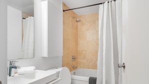 A modern bathroom with a toilet, sink, and shower area.