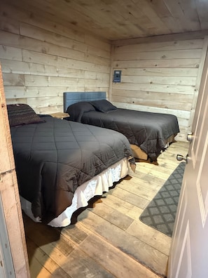A room with two beds, wooden walls, and a wooden floor. - Fabulous cabin in Cordova perfect for your getaway!!! (Cordova)