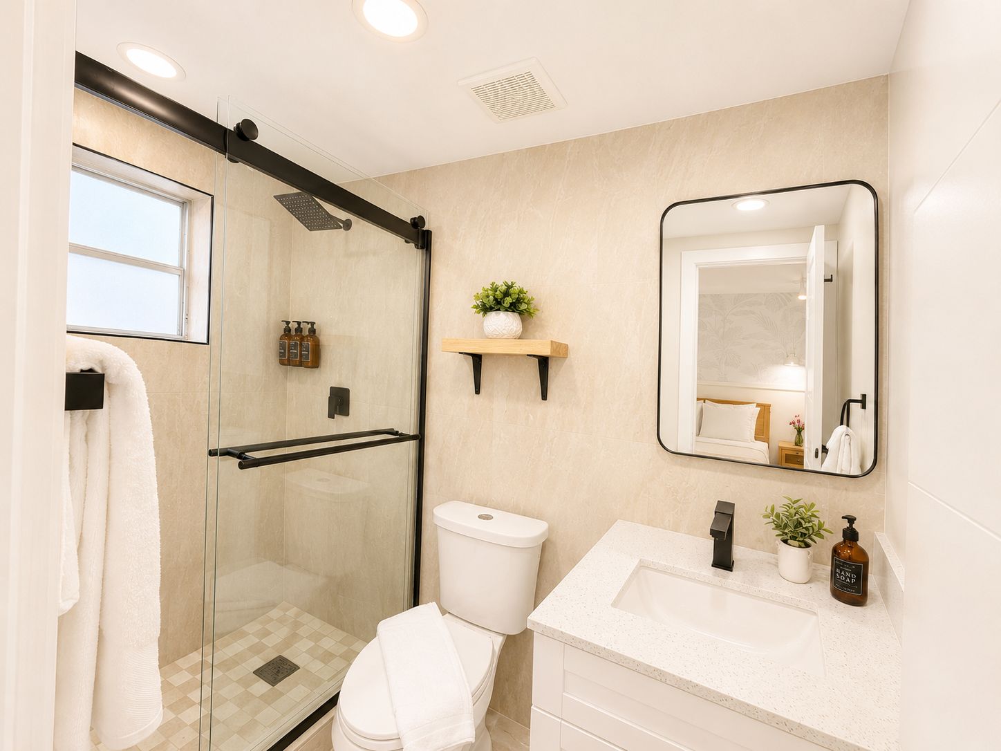 A modern bathroom with a glass-enclosed shower, a toilet, a sink with a mirror, and a shelf with toiletries.