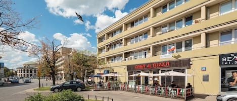 A multi-story building with a restaurant named 'CASA di TUZZA' on the ground floor.