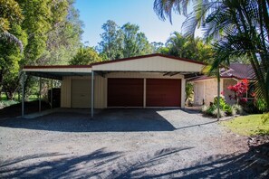 A single-story building with a covered garage and a small attached structure. - Hop, Skip and a Jump - Entire vacation home on acreage (Landsborough)