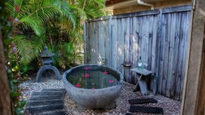 A garden with a stone water feature, steps, and a wooden fence. - Hop, Skip and a Jump - Entire vacation home on acreage (Landsborough)