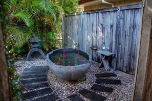 A garden with a stone water feature, steps, and a wooden fence. - Hop, Skip and a Jump - Entire vacation home on acreage (Landsborough)