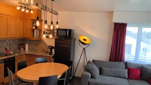 A compact living space with a kitchen, dining area, and seating area.