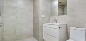 A bathroom with a shower, a sink, and a toilet. - Bright 2-bedroom apartment with AC in charming Southbank (Southbank)