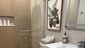 A bathroom with a shower, toilet, and sink. - Sunrise at Sarasota (Sarasota)
