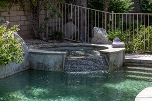 A small water feature with a stone ledge and a metal railing. - Whitehawk Villa | Private Pool & Spa | 3BR | Palm Desert (Palm Desert)
