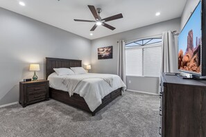 A bedroom with a bed, nightstands, a ceiling fan, a window with blinds, and a TV on a stand. - Horizon Hideaway | Balcony | Pool & Spa | North Scottsdale (Scottsdale)