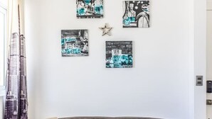 A modern living room with a grey sofa, a throw blanket, and a pillow with motivational text. - Cozy 1BR 1 Min Walk to Beach Pool BBQ Area (Punta Cana)