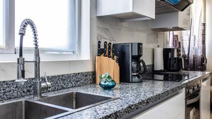 A kitchen with a double sink, a coffee machine, and a knife block. - Cozy 1BR 1 Min Walk to Beach Pool BBQ Area (Punta Cana)