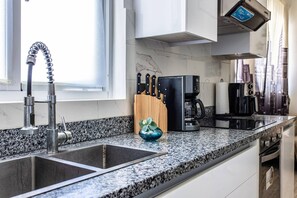 A kitchen with a double sink, a coffee machine, and a knife block. - Cozy 1BR 1 Min Walk to Beach Pool BBQ Area (Punta Cana)
