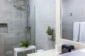 A modern bathroom with a shower, a toilet, a sink with a mirror, and a small plant on the counter. - Cozy 1BR 1 Min Walk to Beach Pool BBQ Area (Punta Cana)