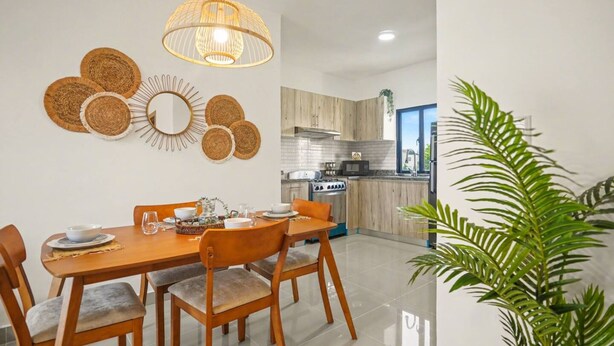 A modern kitchen with wooden cabinets, a built-in oven, and a microwave. - Modern 2BR Pool 5 Min to Coco Bongo Downtown (Punta Cana)