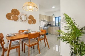 A modern kitchen with wooden cabinets, a built-in oven, and a microwave. - 2BR Pool Downtown Free Electricity (Punta Cana)