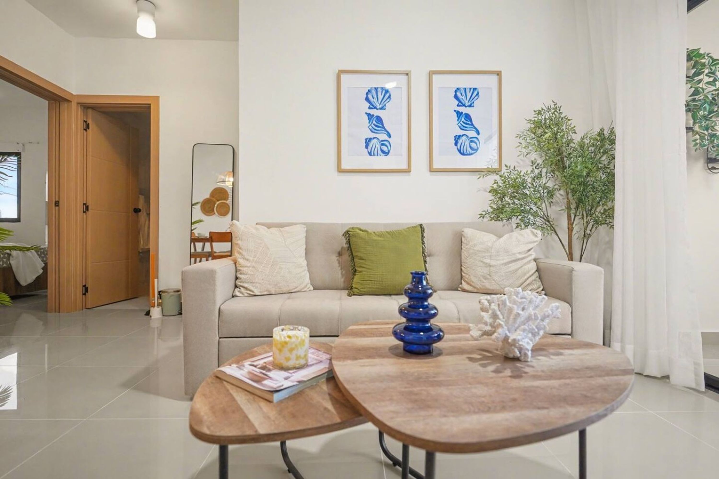 A modern living room with a sofa, coffee table, and decorative items.