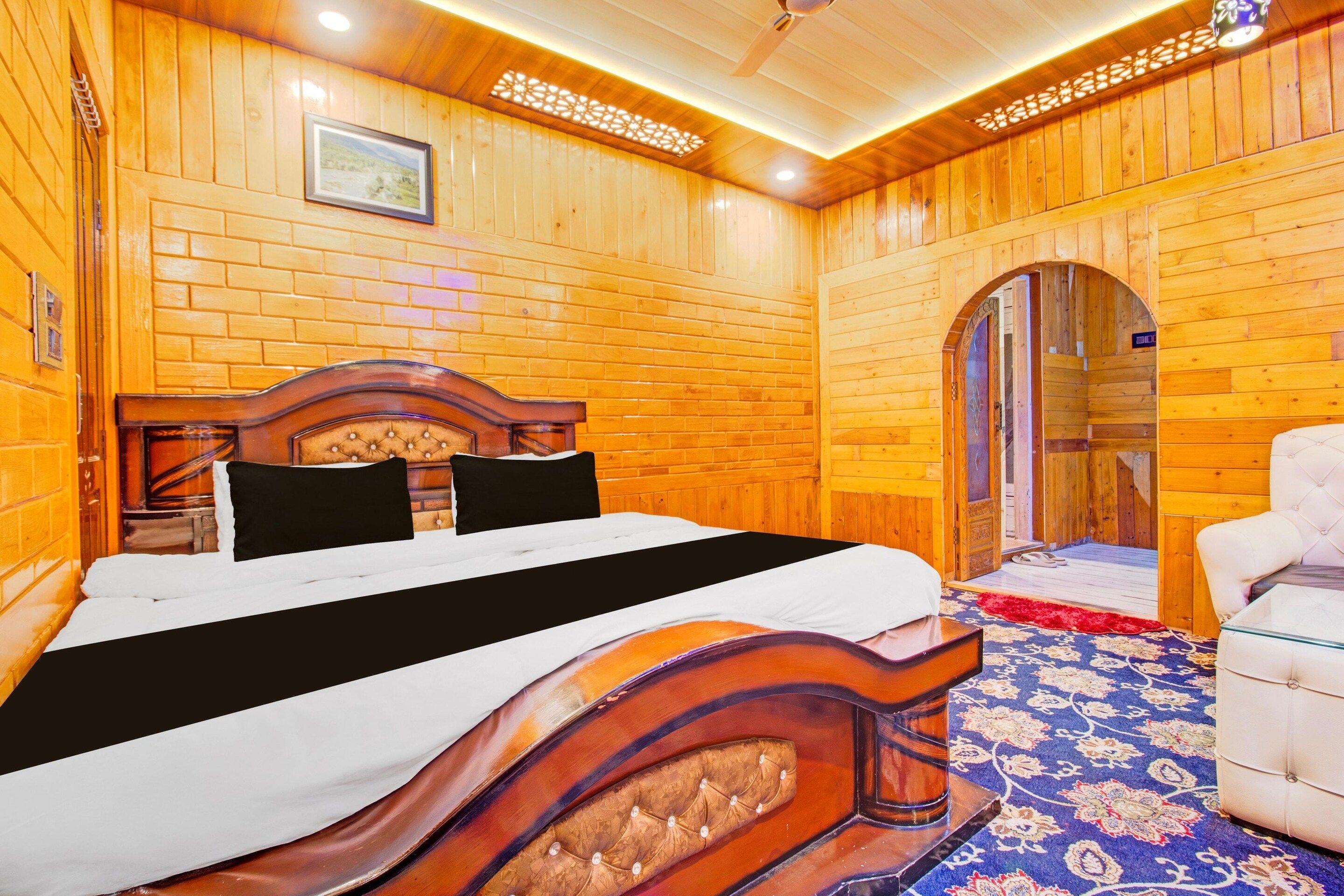 A wooden room with a bed, a chair, and a door.