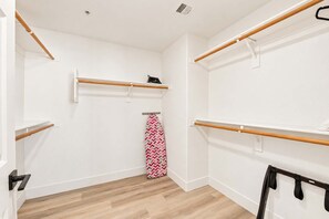 A room with a wooden floor, white walls, and multiple wooden shelves. - CozySuites Glendale - Westgate w pool! 1BR 1BA (Glendale)