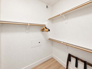 Ein Zimmer mit weißen Wänden, Holzdielen und mehreren an den Wänden befestigten Holzhandläufen.