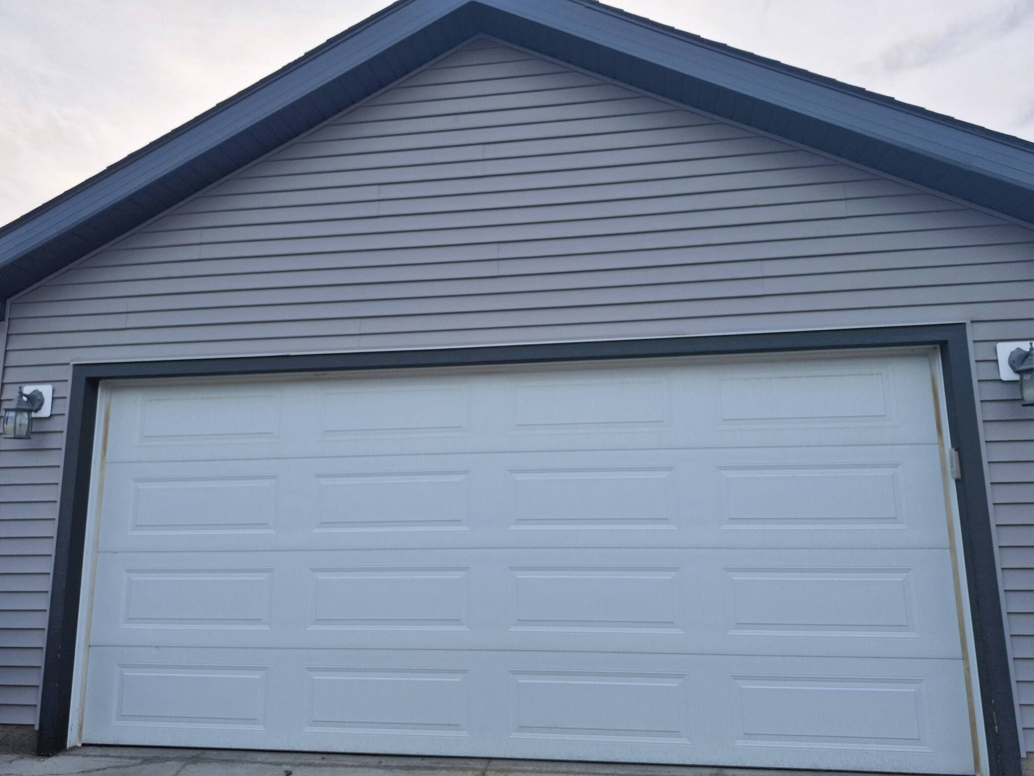 A single-story building with a large garage door.