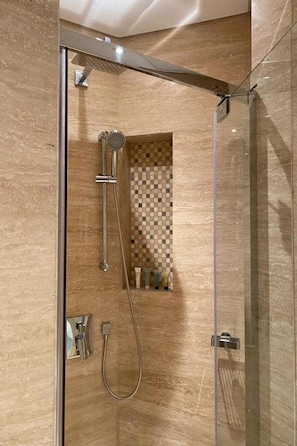 A modern shower with a glass enclosure, a handheld showerhead, and a wall-mounted control panel. - Al Aseel Hotel Doha (Doha)