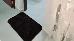 Une salle de bain avec des toilettes, un lavabo et une douche.