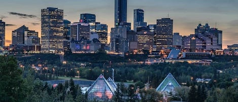 A city skyline with multiple high-rise buildings, including a prominent tall building with a unique design.