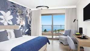 A hotel room with a bed, a desk, a chair, a television, and a balcony with a view. - Zeus Eleva Ajul, a Registry Collection Hotel (Kassandra)