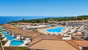 A resort with multiple swimming pools, a beach area, and a view of the sea. - Zeus Eleva Ajul, a Registry Collection Hotel (Kassandra)