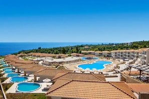 A resort with multiple swimming pools, a beach area, and a view of the sea. - Zeus Eleva Ajul, a Registry Collection Hotel (Kassandra)