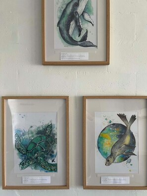 Three framed artworks on a wall.