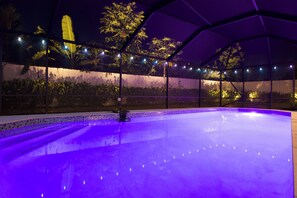 An indoor swimming pool with a tiled edge and a purple light. - Terra Nova at Delray Beach - Minutes To Beach & Atlantic Avenue (Delray Beach)
