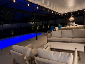 An outdoor patio with a pool, seating area, and a grill. - Terra Nova at Delray Beach - Minutes To Beach & Atlantic Avenue (Delray Beach)