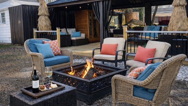 An outdoor seating area with wicker furniture, a fire pit, and a bottle of wine. - Room-red Room DE Spa Access (Dover)