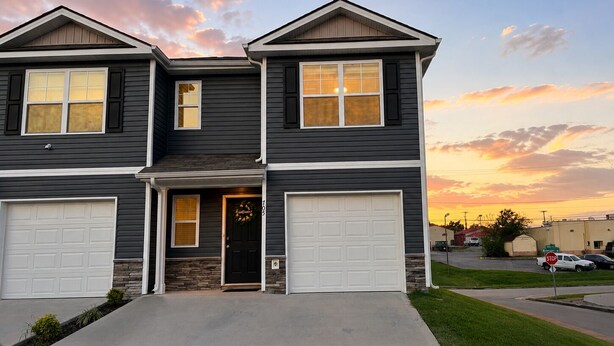 A two-story residential building with a garage, a front porch, and a driveway. - Kingsport Time Capsule - 3 bedrooms near  Eastman and Holston Valley hospital (Kingsport)